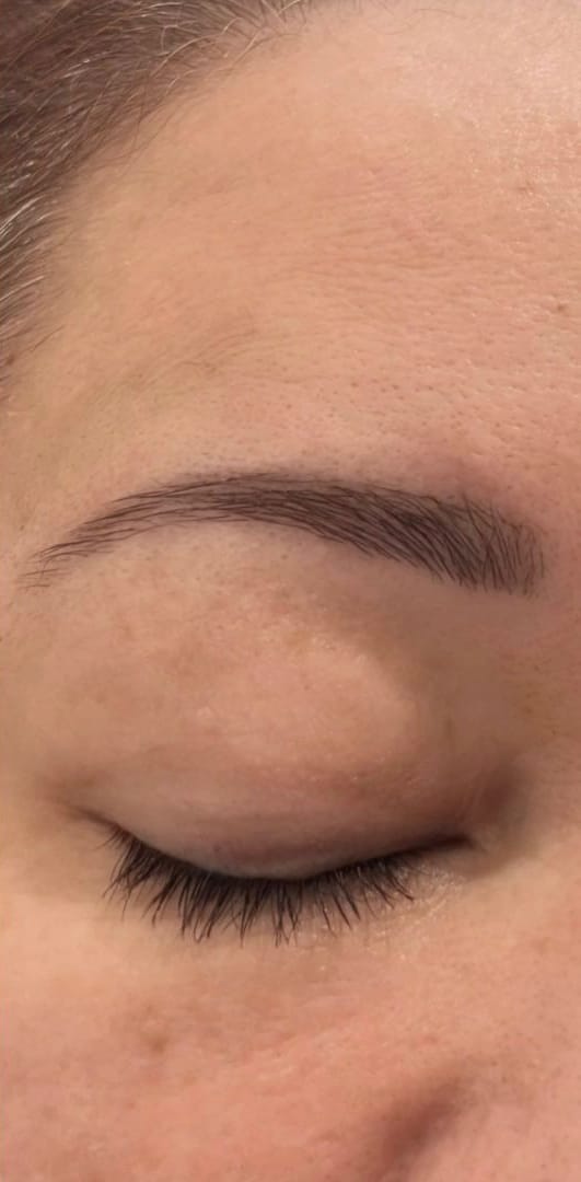 The same brow after shaping and tinting, with a clean defined arch