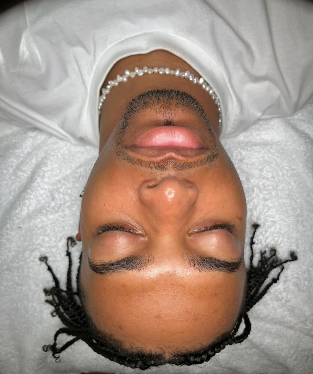 A male client’s clear, freshly treated skin at the end of a facial
